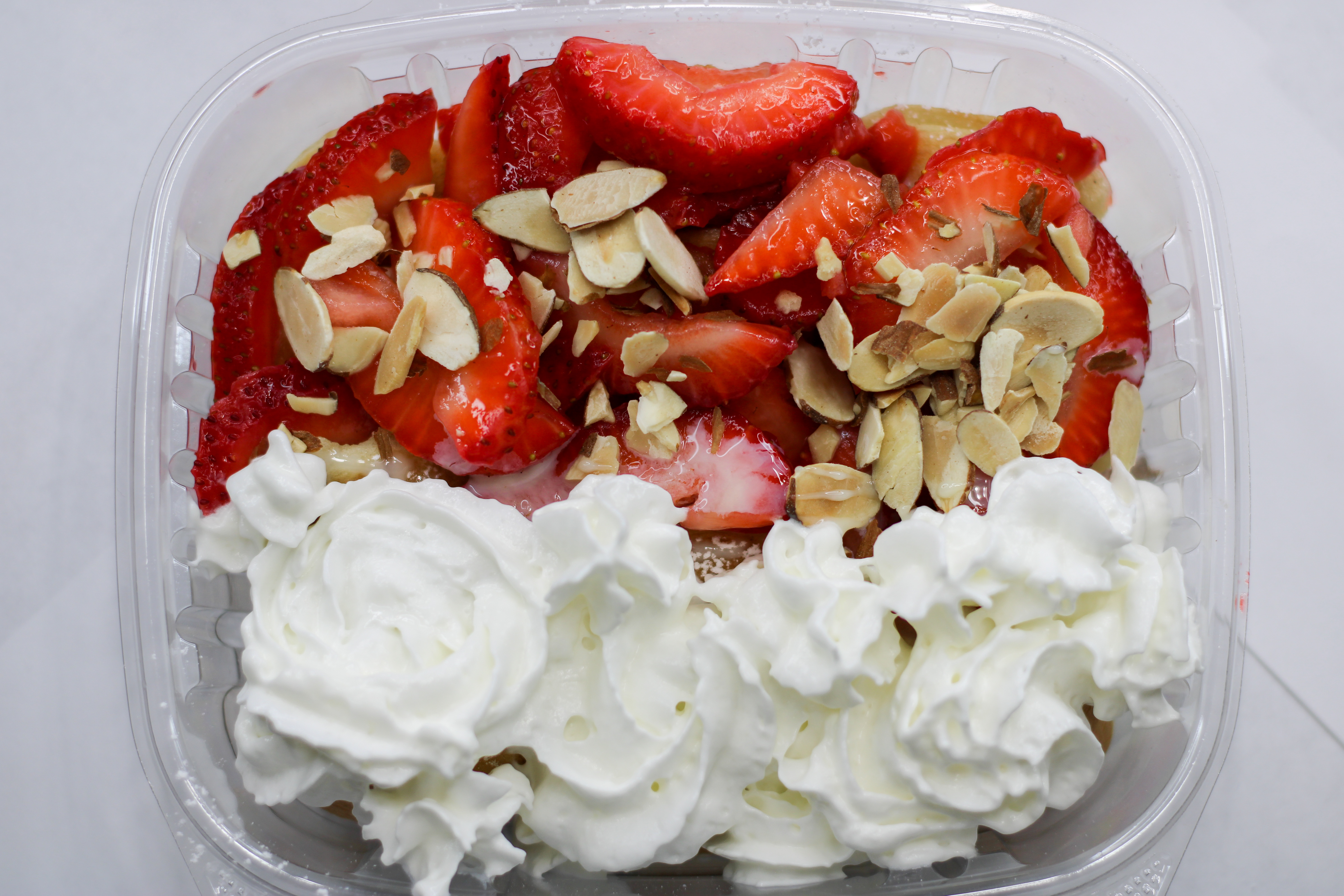 Pancakes with nuts, strawberries, and whipped cream